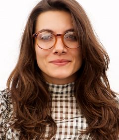 trendy-woman-in-glasses-standing-by-white-wall-5NF8L4S-1.jpg